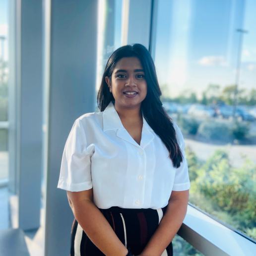Yashvi Limbasiya posing and smiling by a window